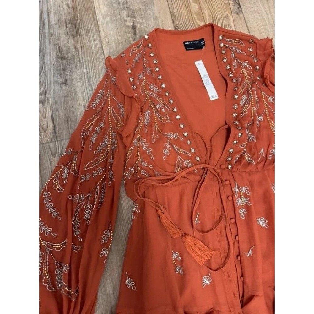 midi dress with button front and trailing floral embellishment in rust